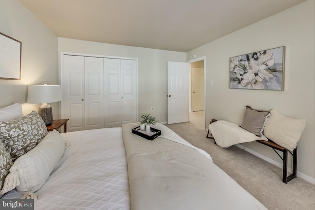 bedroom featuring a closet and light colored carpet