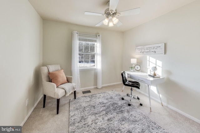 carpeted office space featuring ceiling fan