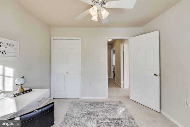 carpeted bedroom with ceiling fan and a closet