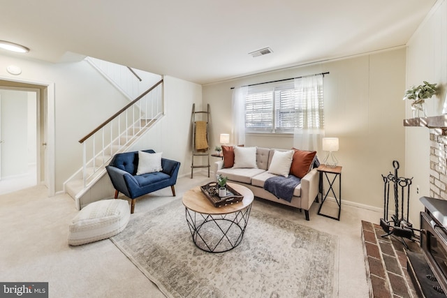 living room featuring a brick fireplace and carpet flooring