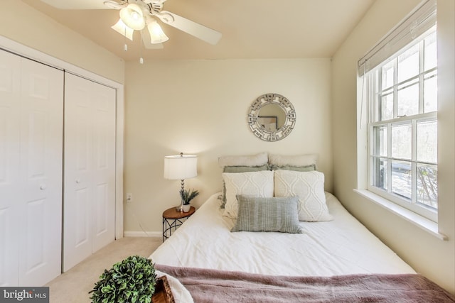 carpeted bedroom featuring ceiling fan and a closet