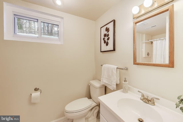 bathroom with toilet, vanity, and a shower with curtain