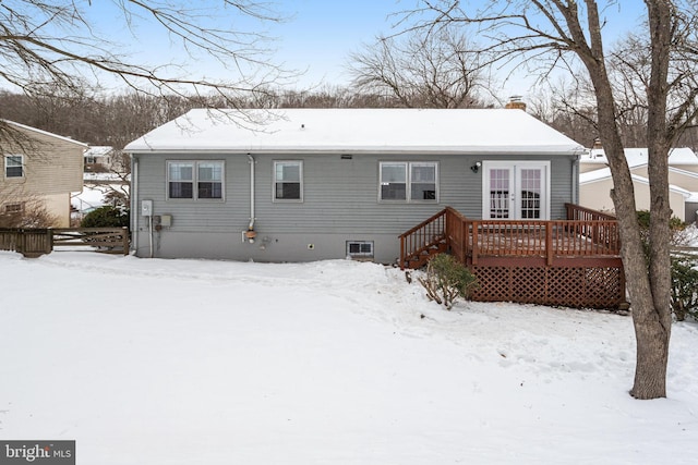 snow covered property with a deck