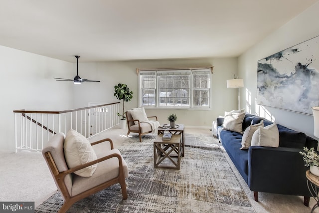 living room with ceiling fan, plenty of natural light, and carpet flooring