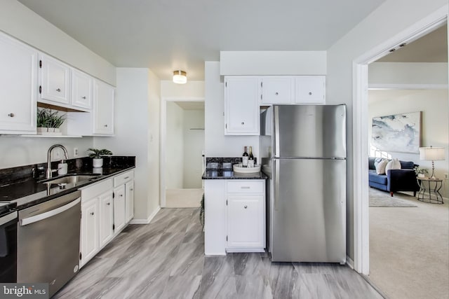 kitchen with sink, white cabinets, and appliances with stainless steel finishes