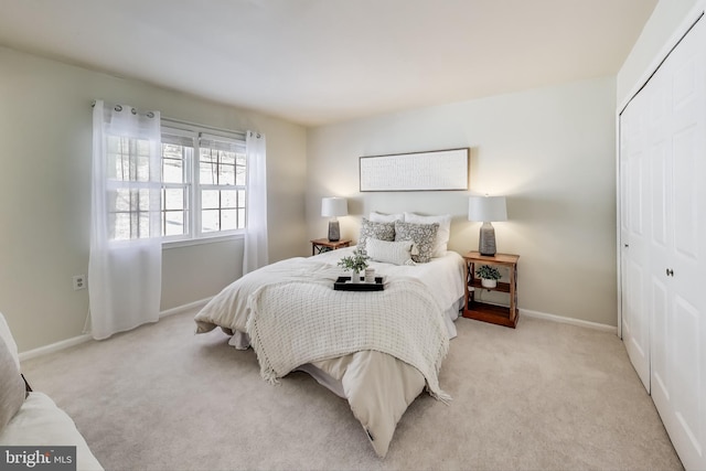 bedroom with a closet and light colored carpet