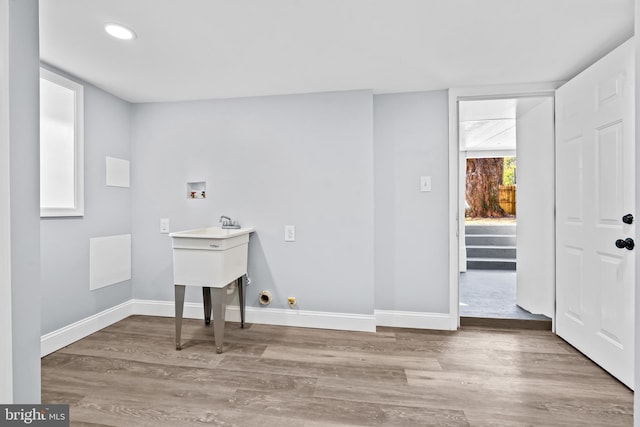 laundry room featuring hookup for a washing machine, hardwood / wood-style flooring, and hookup for a gas dryer