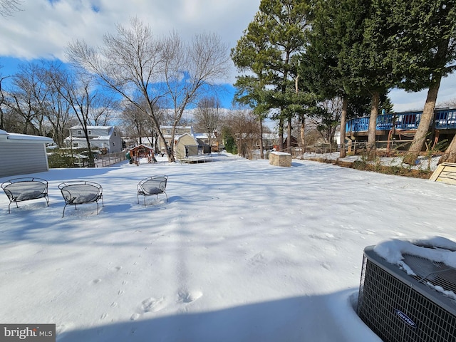 yard covered in snow with a fire pit and cooling unit