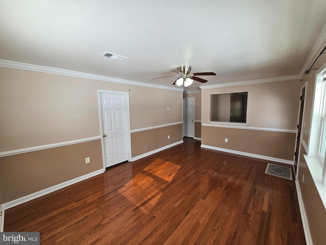 unfurnished living room with ceiling fan, crown molding, and dark wood-type flooring