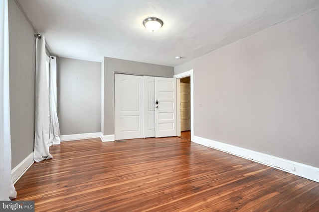 unfurnished bedroom with wood-type flooring and a closet