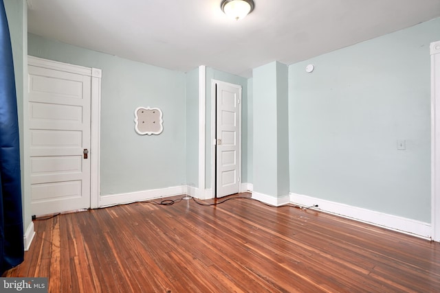 empty room featuring dark wood-type flooring