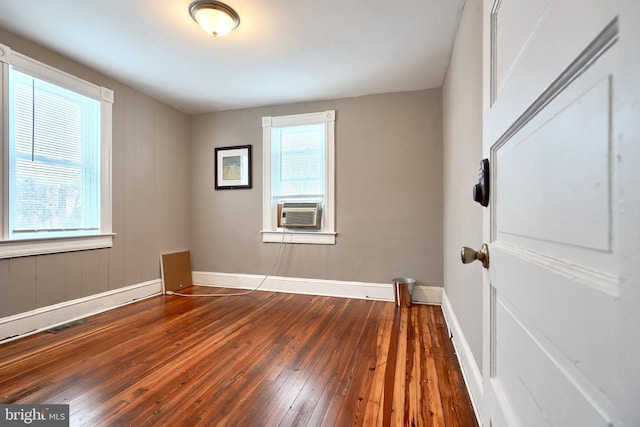 empty room with dark hardwood / wood-style flooring and cooling unit