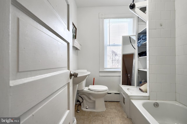 bathroom with a bathing tub, a healthy amount of sunlight, a baseboard radiator, and toilet