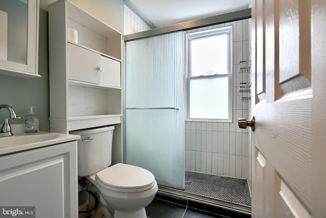 bathroom with tile patterned floors, vanity, toilet, and walk in shower