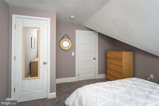 carpeted bedroom with lofted ceiling