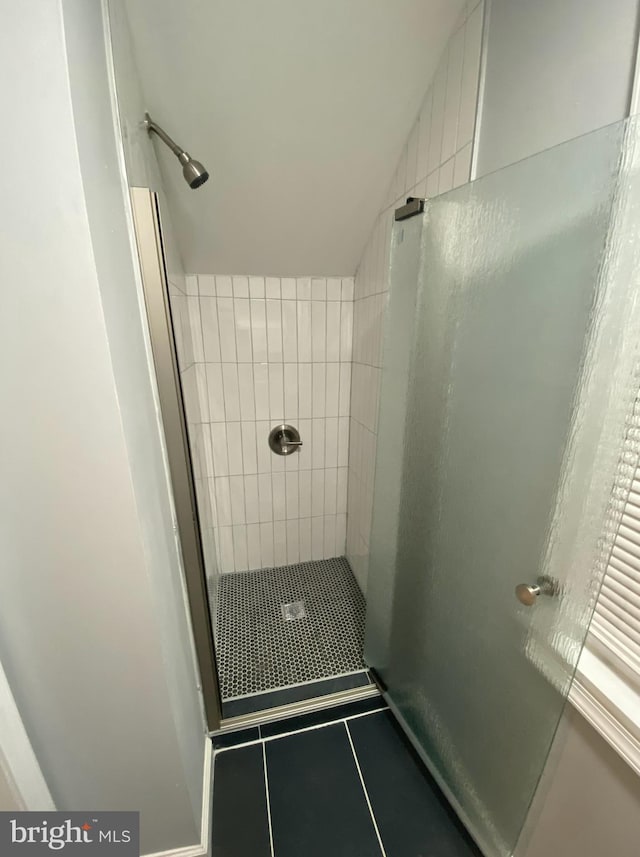 bathroom featuring tiled shower and tile patterned floors