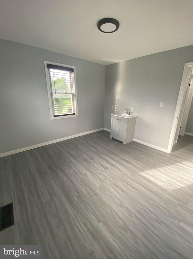 empty room with wood-type flooring