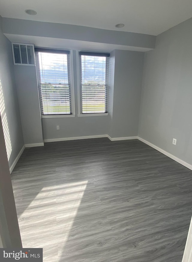 unfurnished room featuring dark wood-type flooring