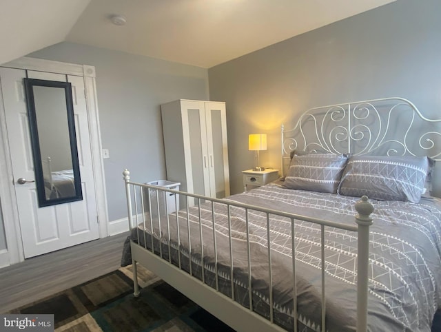 bedroom with hardwood / wood-style flooring and vaulted ceiling