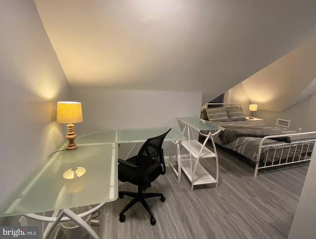 bedroom featuring wood-type flooring and lofted ceiling