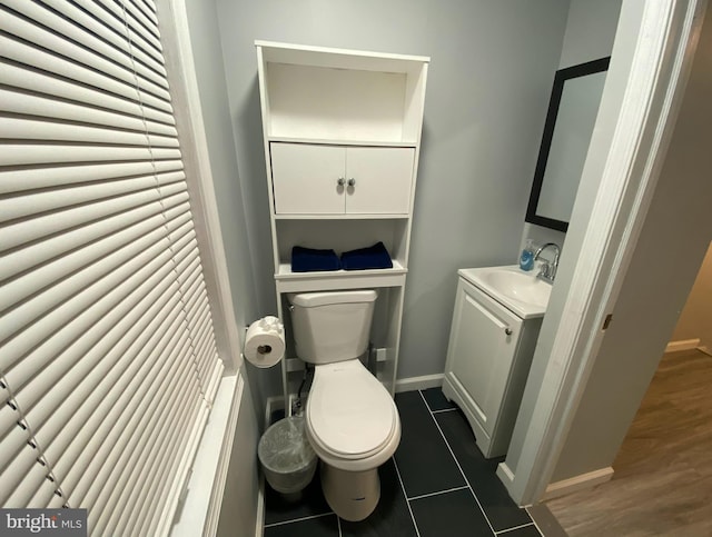 bathroom with tile patterned flooring, vanity, and toilet