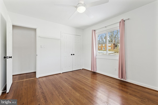 unfurnished bedroom with ceiling fan, a closet, and hardwood / wood-style floors