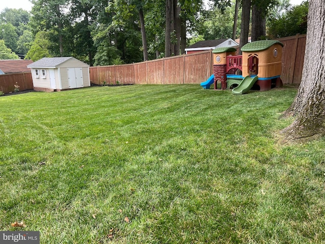 view of yard featuring a playground and a shed