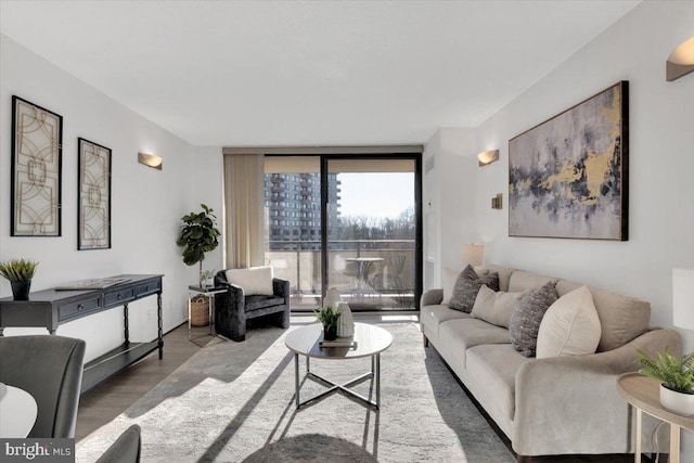 living room with expansive windows and dark hardwood / wood-style flooring