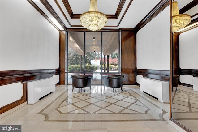 home theater room with ornamental molding and an inviting chandelier