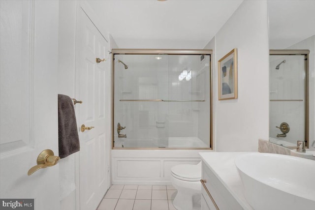 full bathroom with enclosed tub / shower combo, tile patterned floors, vanity, and toilet