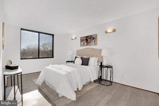 bedroom with hardwood / wood-style flooring