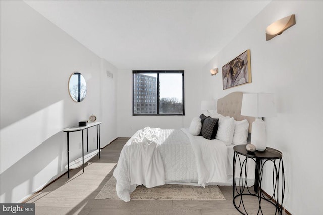 bedroom with hardwood / wood-style flooring