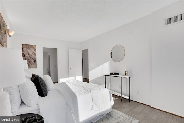 bedroom with hardwood / wood-style floors