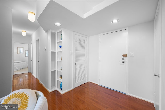 interior space with hardwood / wood-style floors and built in features