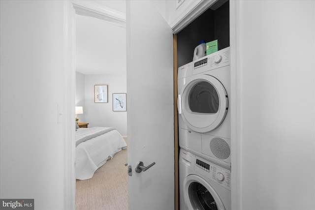 laundry room featuring stacked washer and clothes dryer