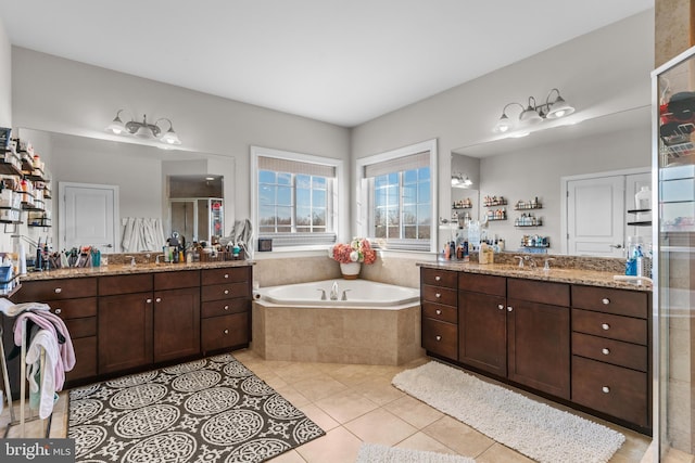 bathroom with tile patterned floors, shower with separate bathtub, and vanity