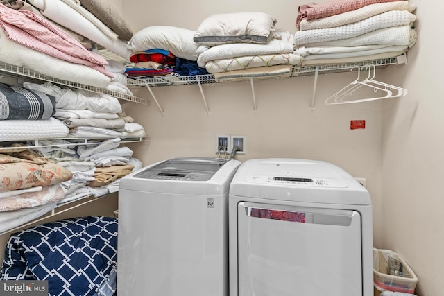 clothes washing area with separate washer and dryer