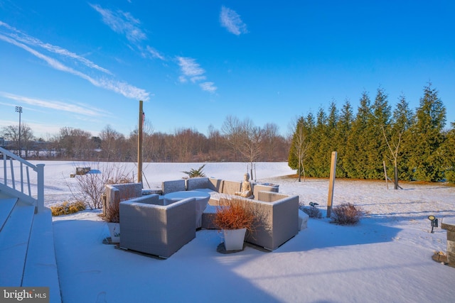 snow covered patio featuring a fire pit