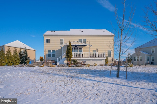 view of snow covered back of property