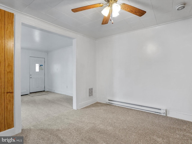 empty room with ceiling fan, carpet floors, and a baseboard heating unit