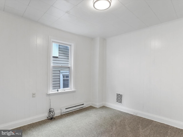 carpeted spare room featuring ornamental molding and a baseboard heating unit