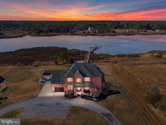 aerial view at dusk with a water view