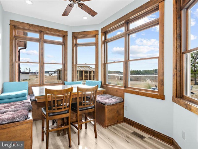 sunroom featuring breakfast area and ceiling fan