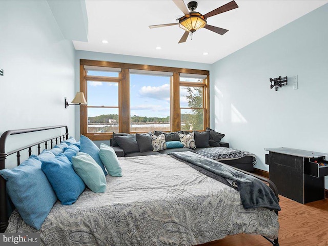 bedroom with wood-type flooring and ceiling fan