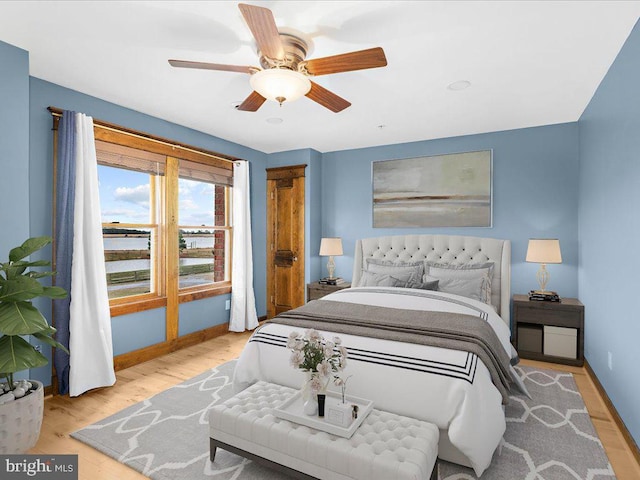 bedroom with ceiling fan and light hardwood / wood-style flooring