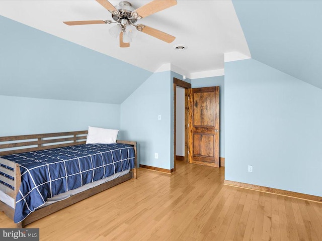 bedroom with light wood-type flooring, ceiling fan, and lofted ceiling