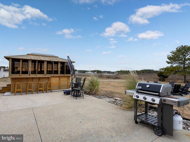 view of patio / terrace featuring area for grilling and a bar