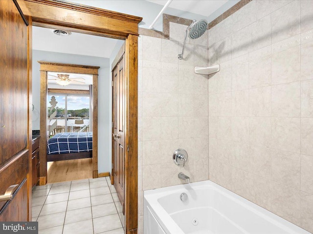 bathroom with tile patterned floors, tiled shower / bath, and ceiling fan