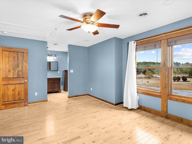 living room featuring light hardwood / wood-style floors and ceiling fan