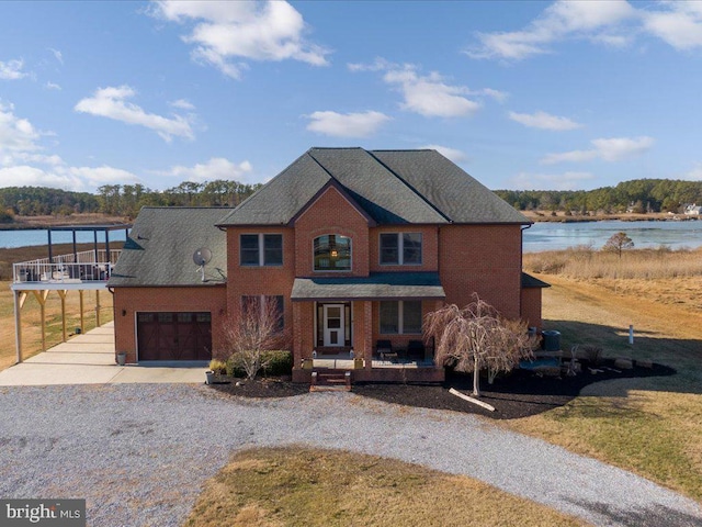 view of front facade featuring a water view and a garage